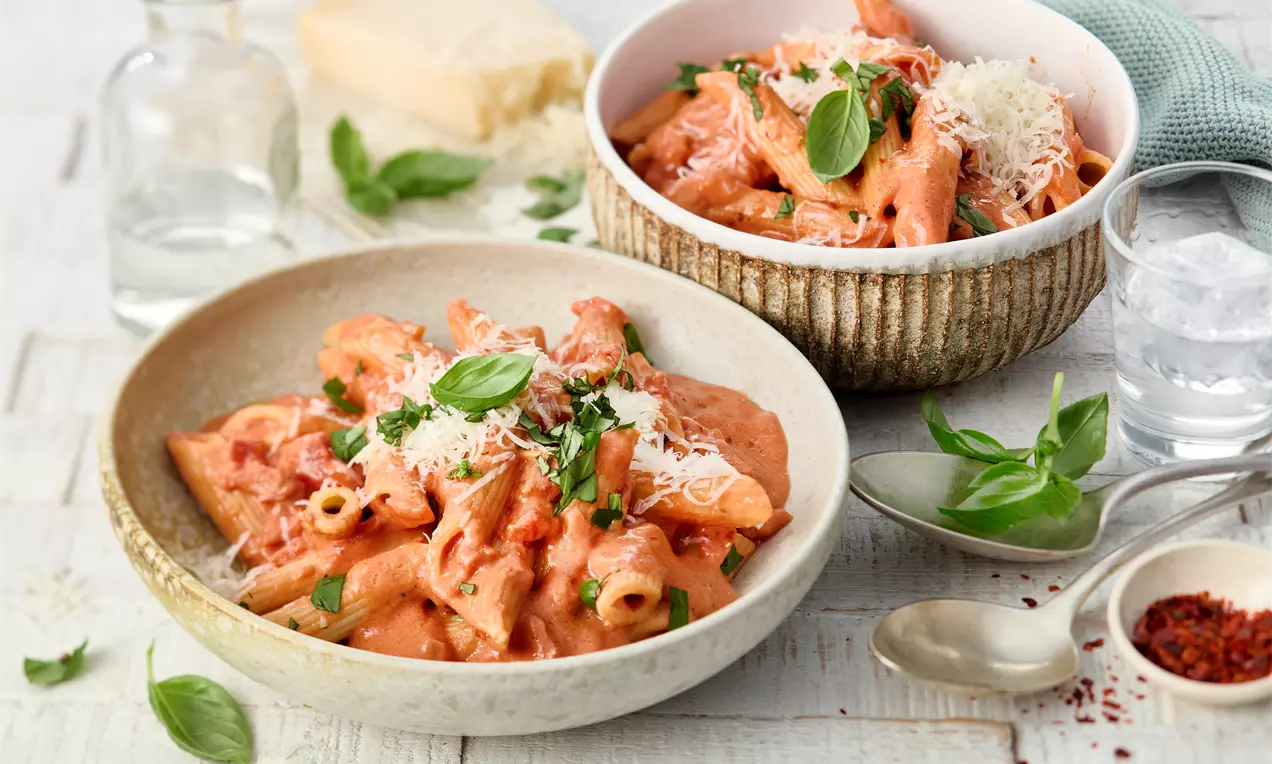 in Schalen Pasta mit cremiger Tomaten-Wodka-Soße, Crème fraîche und Parmesan – einfaches Pasta-Rezept für würzige Genussmomente. Perfekt für schnelle, gemütliche Abendessen!